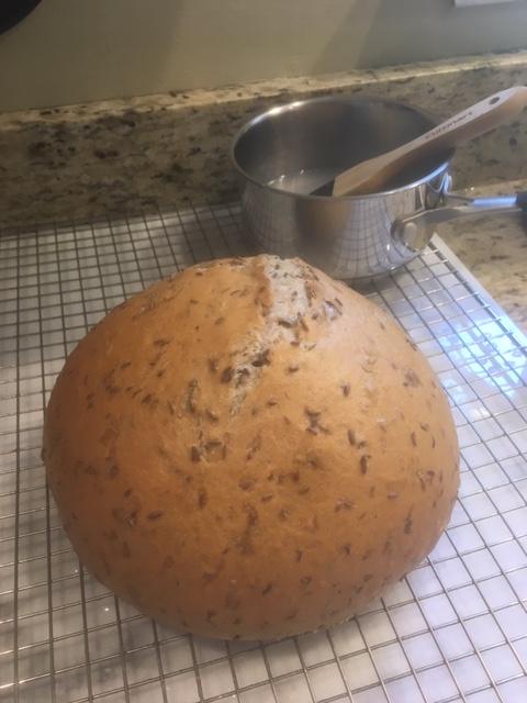 This was my 3rd attempt at a sourdough loaf, and despite only having a cast  iron skillet and a metal mixing bowl as a Dutch oven, I think it turned out  pretty