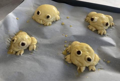 Four sad-looking unbaked dough frogs