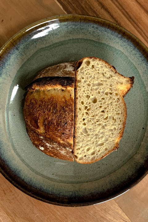photo of the loaf from the top down, it is cut in half exposing the interior crumb