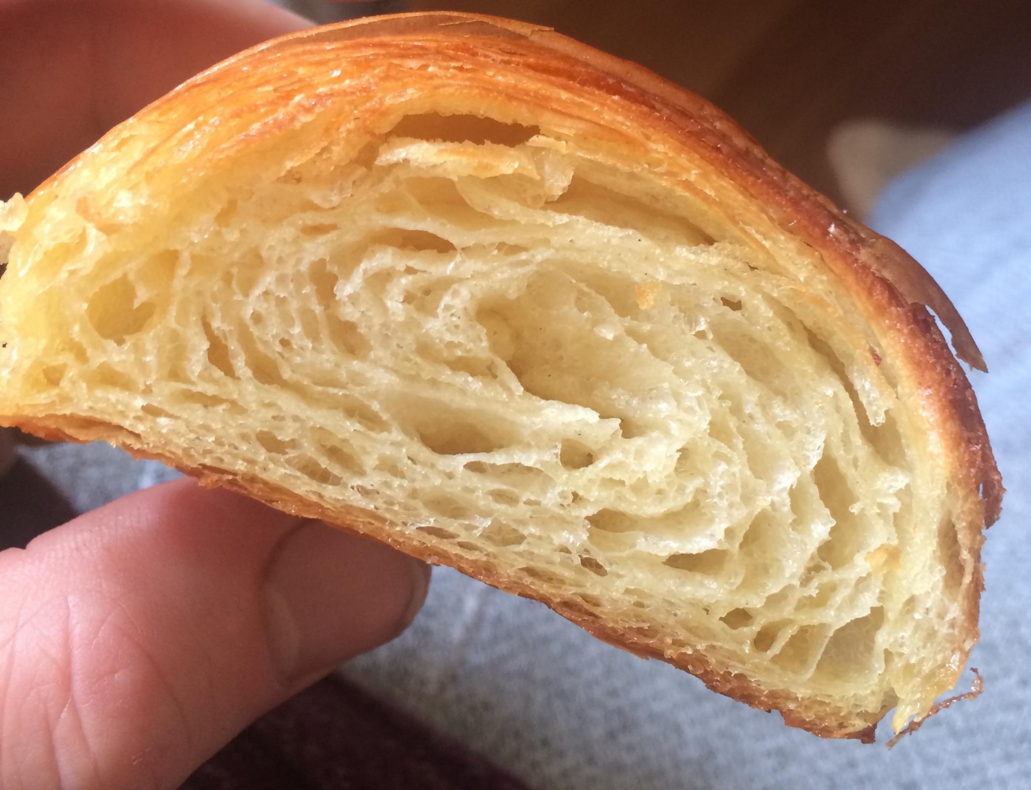 how improve from here to get a more open crumbok so a couple tries later and the lamination I feel is much more precise (12 folds in total).  A 2:1 mix of strong 00 flour (I use for pizza) and all - purpose flour, 60 % hydration dough, 1.5 % yeast, 2 % salt, 12.5 % sugar, I didn't use egg milk or butter in as i thought thiis might make the butter less mixable with the dough. I ferment over night in the fridge before encasing the dough the next morning, purposely not develeping much gluten when i make the dough kneading much less then i would for bread.  The beurrage is 50% the totalweight of the flours  It is a bit warm at the moment in my kitchen, temperature ranges from about 22 to 25.5 over the 2 hours I was proofing in the oven (turned off!) with a small tray of hot water to create some steam (not enough to increase the temperature of the oven.  They roughly double in size and I preheat oven to max and then turn down to 200 c once i put them in.  very small amount of butter leakage during baking.    Like I say lamination I think is much improved I can see clear layer after shaping but I want to achieve that honeycomb structure https://www.google.com/search?q=dominique+ansel+croissant+recipe&rlz=1CAKSOU_enGB869&sxsrf=ALeKk01C0L7fStYYzY0GPyQDSwoRECgKOw:1586721763935&source=lnms&tbm=isch&sa=X&ved=2ahUKEwjm2eKY1-PoAhWVh1wKHTkeCiQQ_AUoAXoECBAQAw&biw=1366&bih=641#imgrc=aQZosx6Au7elgM  which im not far off but still not got it    my guess is shapping? or dough recipe or proofing (perhaps over proofing now?) struture (honeycomb?)