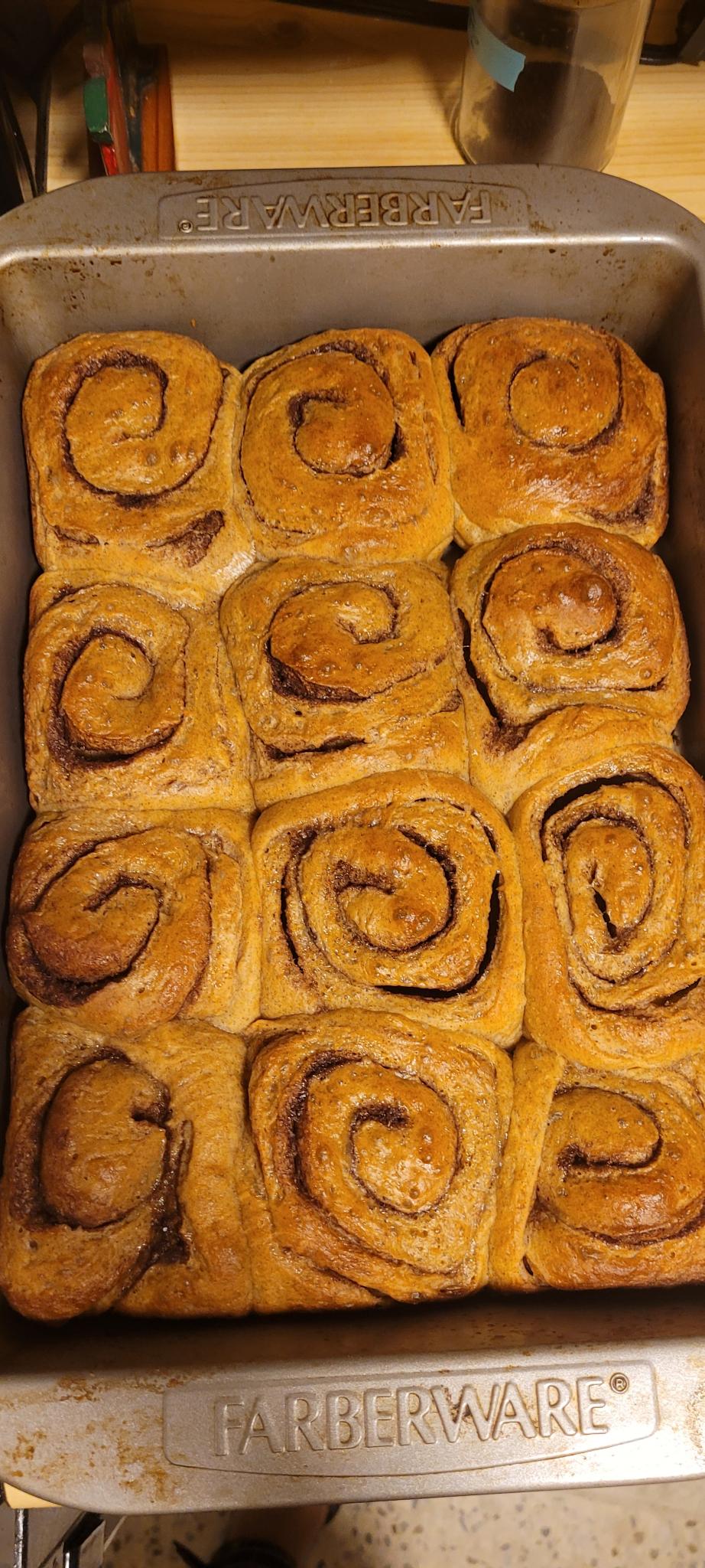 pumpkin cinnamon roles in a baking tray