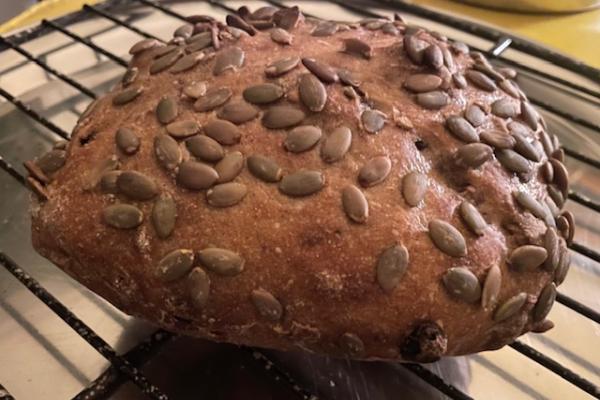 a bread with pumpkin seeds on the crust