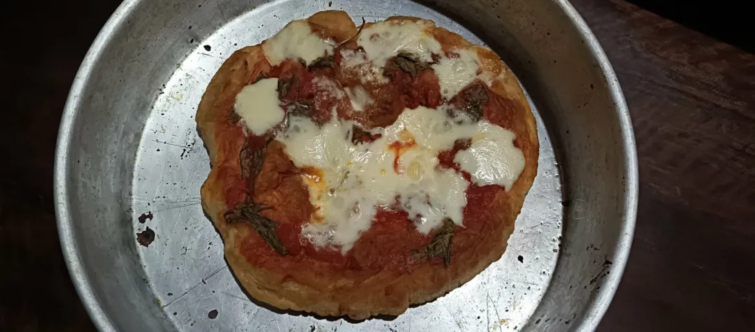 Montara-style Pizza. Fried Pizza dough topped with tomatoes, cheese and basil; then baked until crisp.